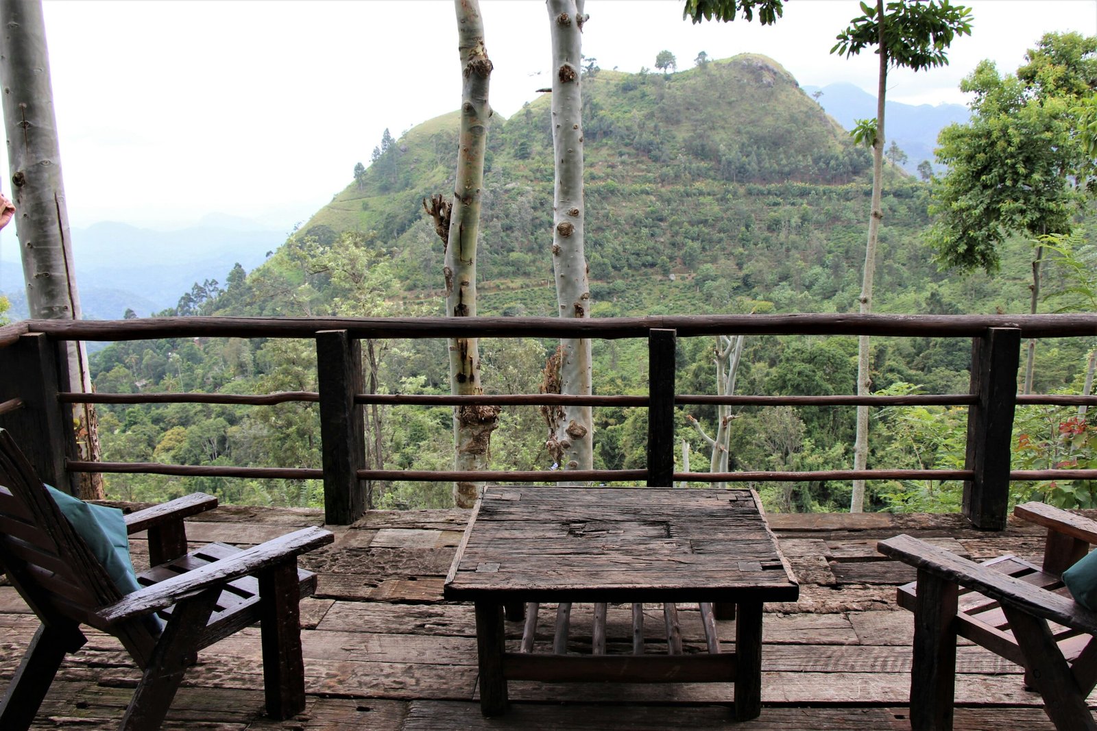 brown wooden patio table and chairs in front of mountain view